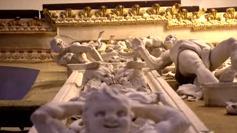 stuccoes and statues inside the serpotta chapel of castelbuono castle, sicily. angels, devils, and fierce demonic faces decorate this masterpiece, showcasing baroque artistry at its finest.