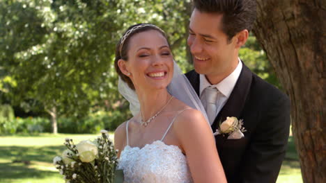 newlyweds standing in the park