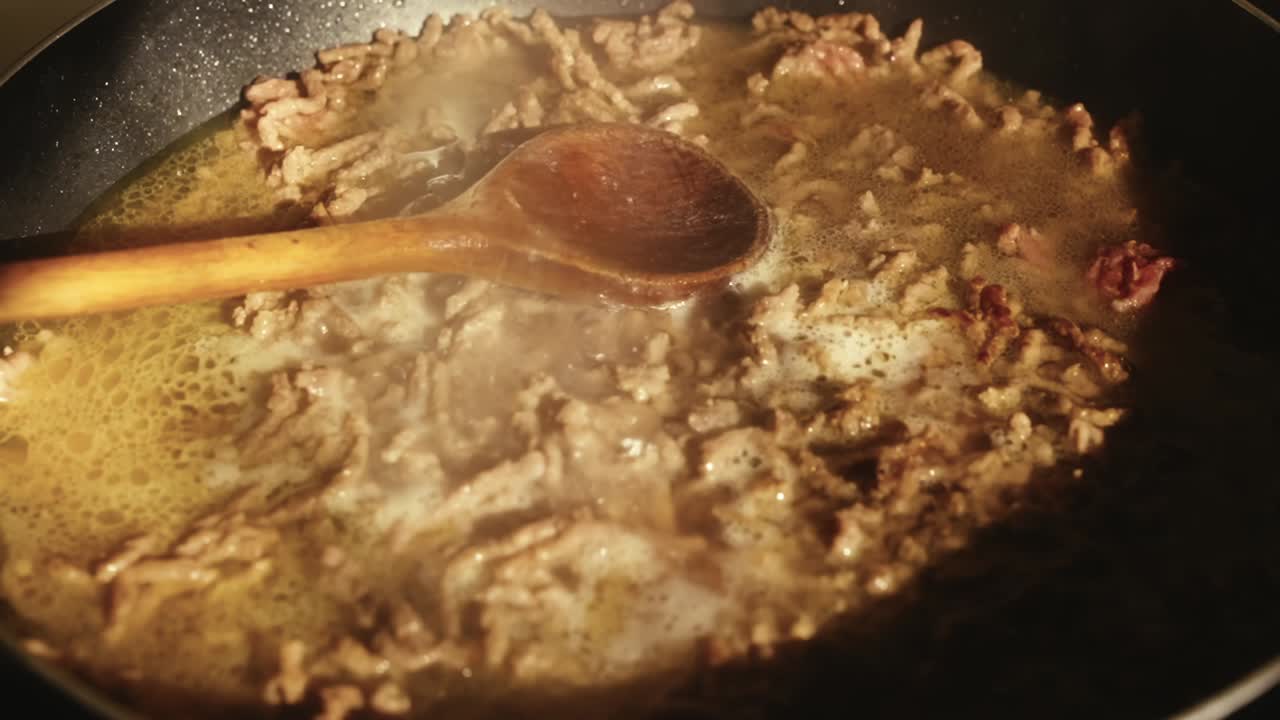 Boiling beef in a black pan