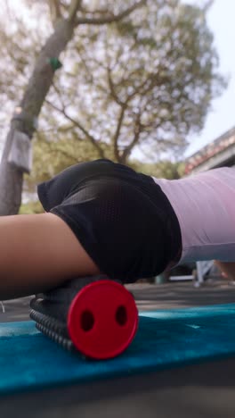 woman doing outdoor foam rolling exercises