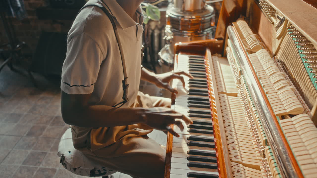 Man playing vintage piano in a music studio