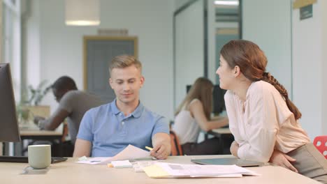 Business-team-discussing-project-at-coworking.-Happy-team-looking-startup-charts