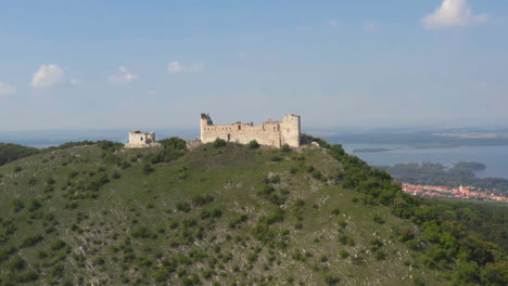 ruins of stone castle děvičky in moravian countryside, drone shot