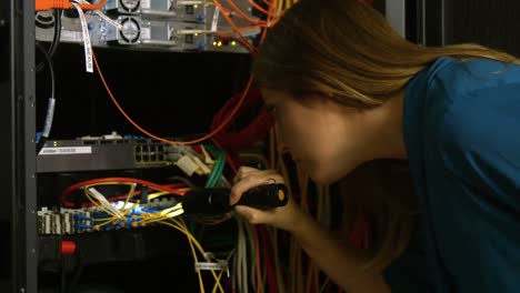 technician looking at open server locker