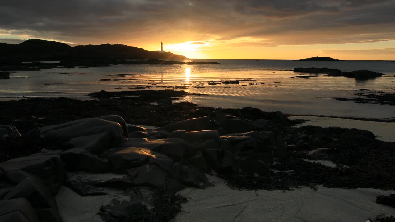 Sunset at Ardnamurchan Lighthouse and sandy beach, west coast of Scotland