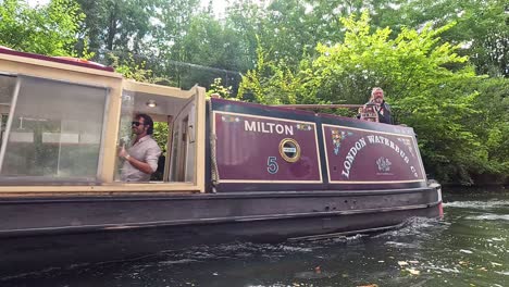 a narrow boat cruising through camden town