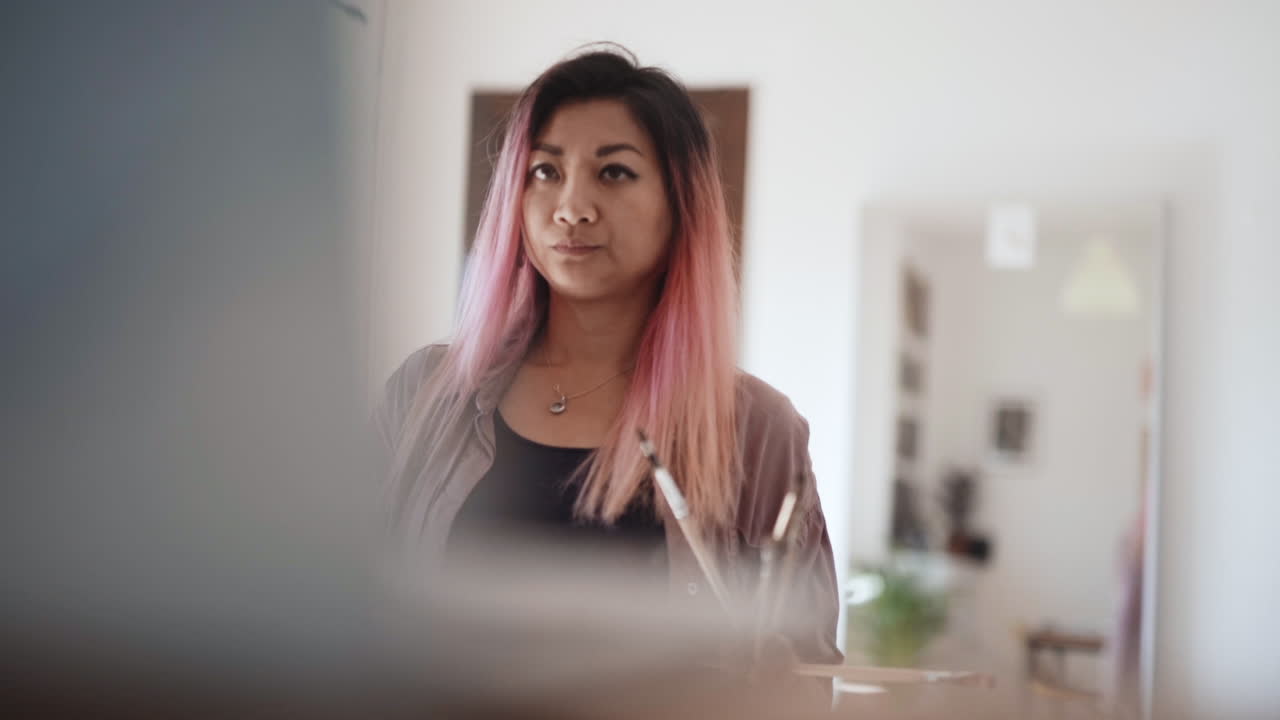 asombrada artista coreana admirando su trabajo creativo