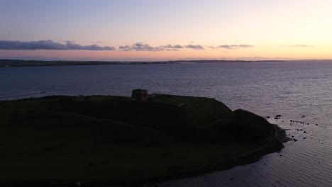 Aerial-footage-of-the-Kaløvig-ruin-off-the-coast-in-Jutland,-Denmark