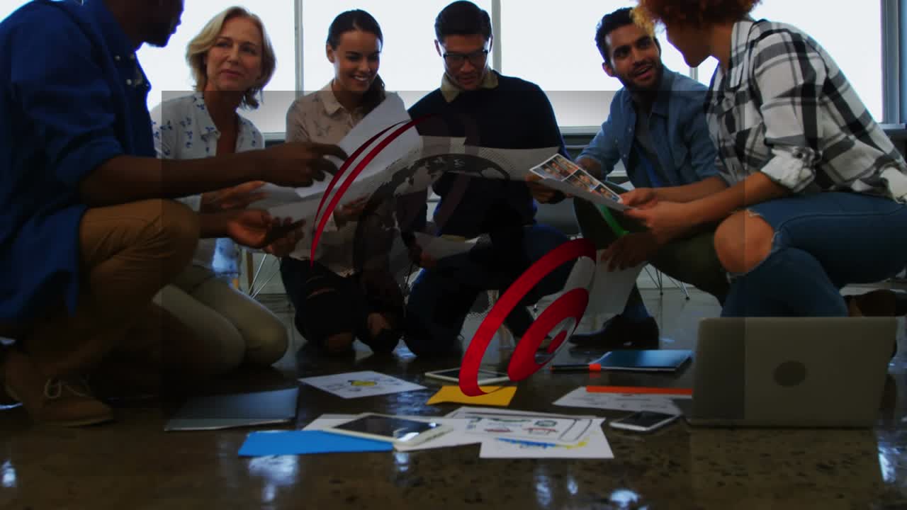 Animation of globe over diverse business people at office