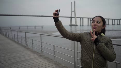 happy hindu woman posing and gesturing for selfie