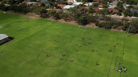 orbit shot of amateur soccer football match with lateral pass, perth city, western australia