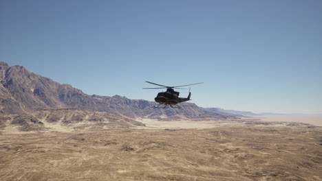 helicopter flying over a desert landscape