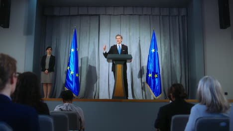 press conference by a politician in front of european union flag