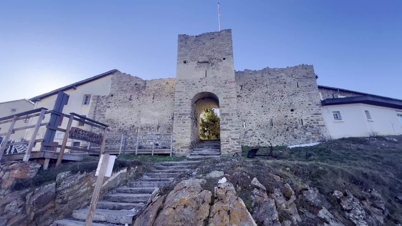 A moving frame with the medieval entrance gate in the ski resort of Les Angles, France