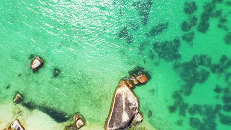 Tropical-azure-sea-with-rocky-shore