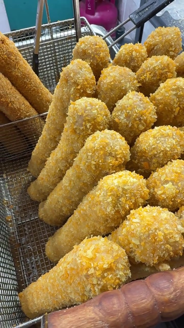 Freshly Fried Crispy Corn Dogs in a Metal Basket