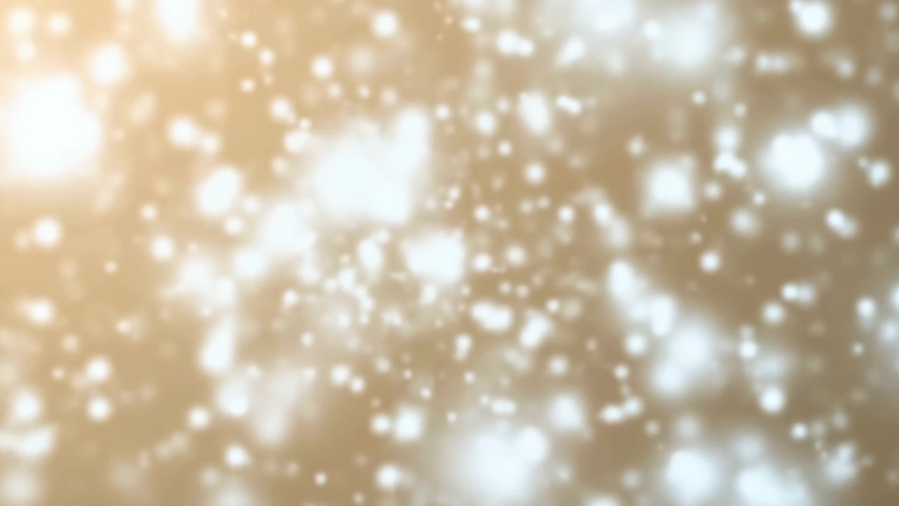 Hạt bokeh vàng ấm trôi nổi, những quả cầu phát sáng mềm mại lơ lửng trên nền kem tạo không khí lễ hội.