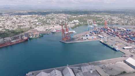 huge cargo cranes in port of haina, aerial backwards, establish container site