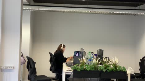 woman using audio headset to have conversation at call center job with helpline clients, helping with telemarketing assistance