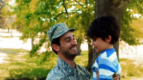 Soldado-Del-Ejército-Levantando-Niño