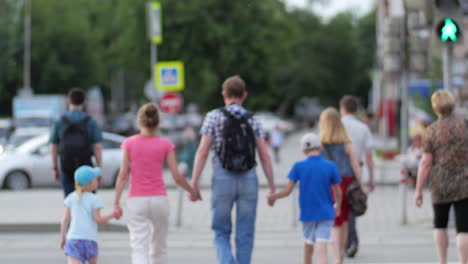 family crossing the street