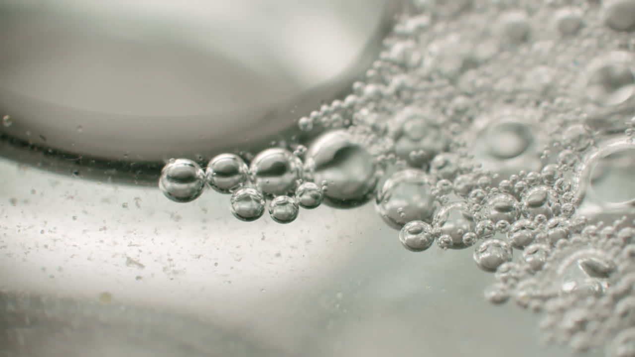 foto macro de pequeñas burbujas de aire que se mueven en un líquido viscoso transparente formando diferentes formas