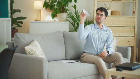 Man-Flies-Paper-Airplane-at-Home