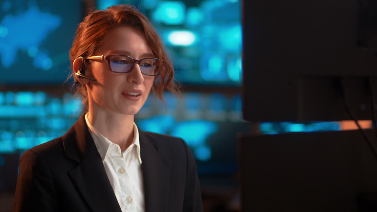 Slow pan, a businesswoman at work talking through her bluetooth headset, in a customer service-type industry, having some tooth discomfort