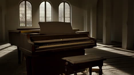 dusty grand piano in an old, sunlit room