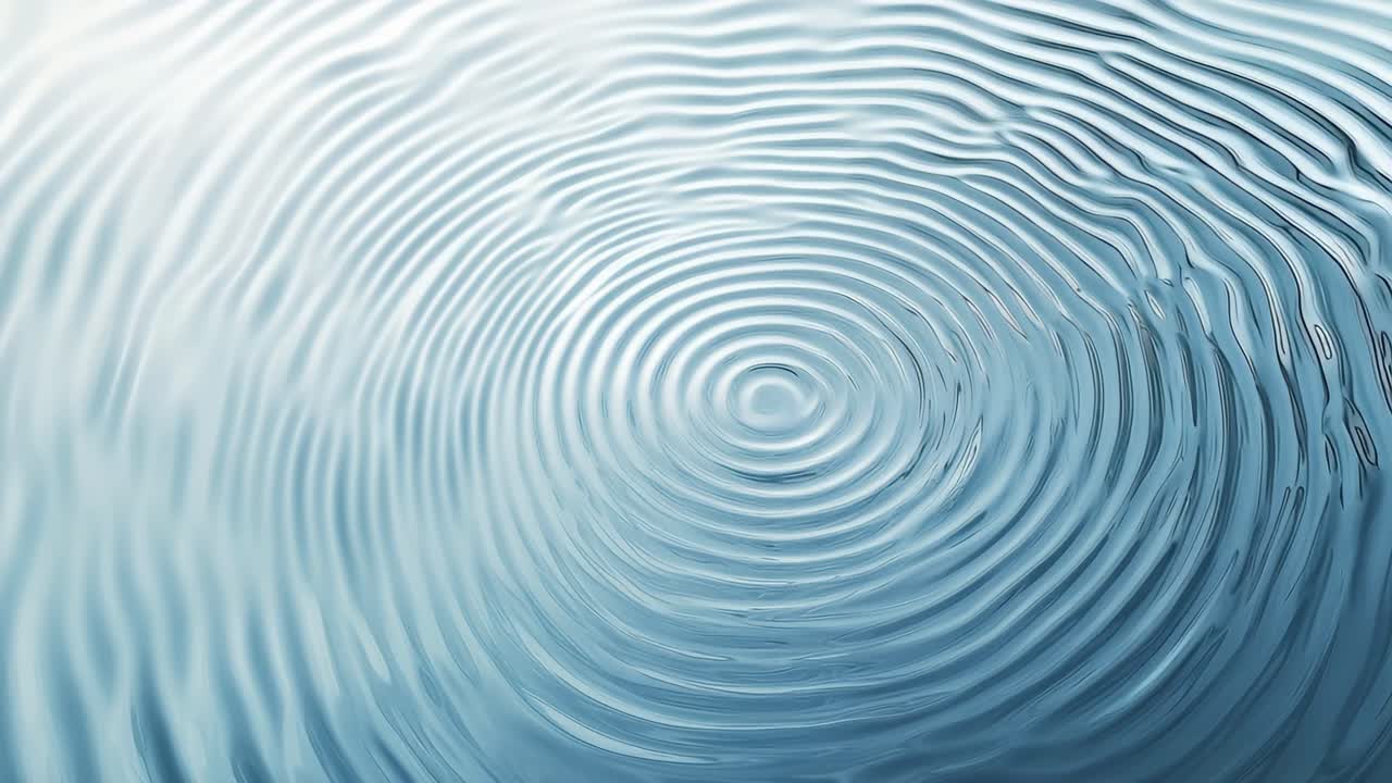Top-down view of rippling water, creating concentric circles. The serene video captures the calming