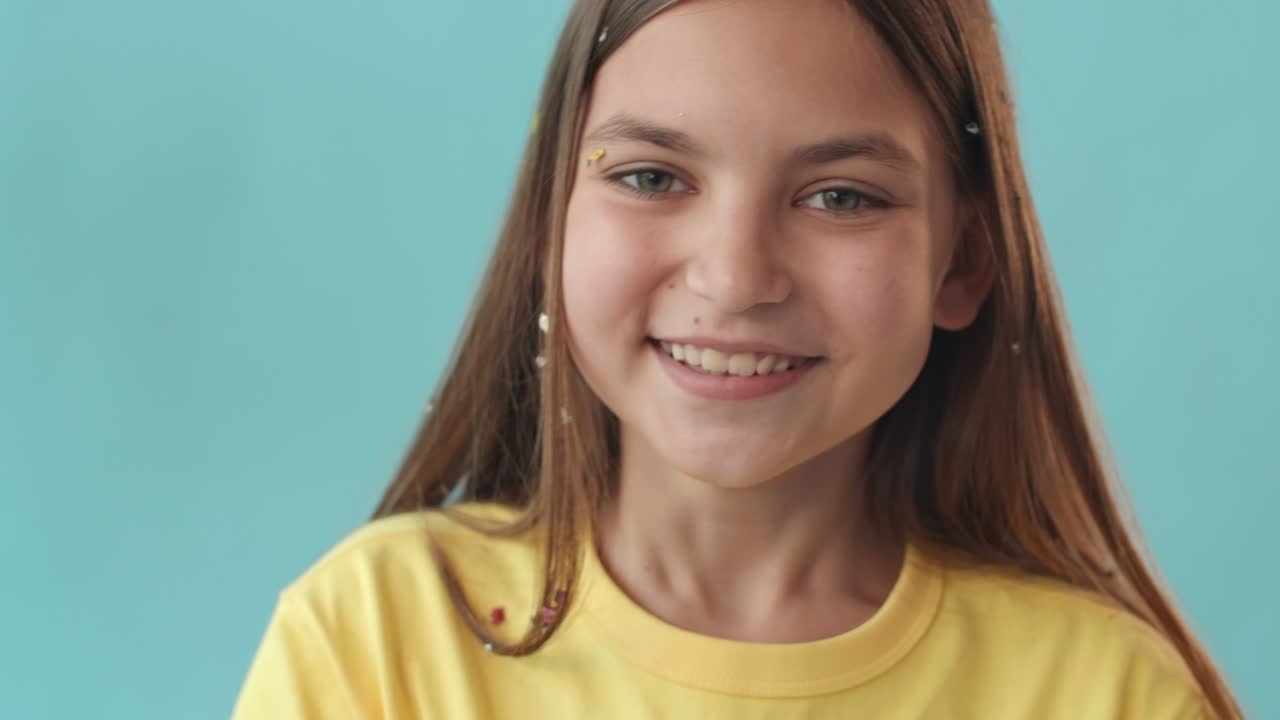 Girl Blowing Sparkles on Camera