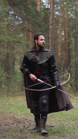 knight in armor walks through forest with bow and arrow, historical role-playing games, medieval costume