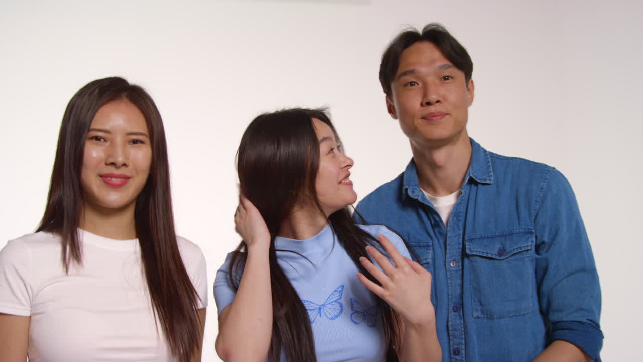 Group Of Young Friends In Front Of White Studio Background Posing For Photo Booth Style Portraits
