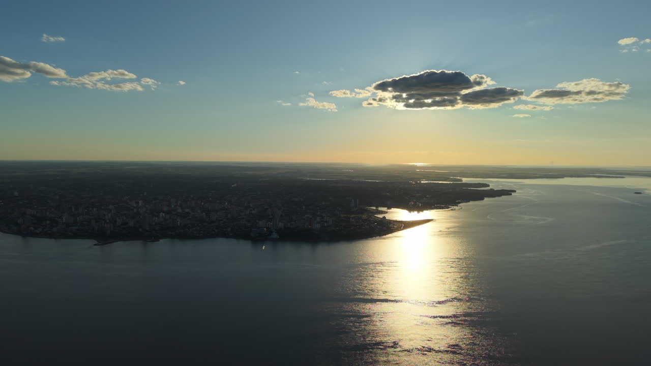 Sunset coastline aerial view of Misiones City of Argentina, Posadas River reflected on water