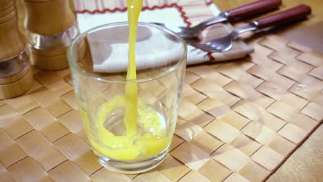 orange juice pouring into a glass, the morning breakfast. slow motion with rotation tracking shot.