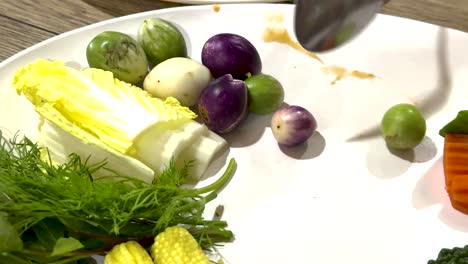 assorted vegetables arranged on a white plate