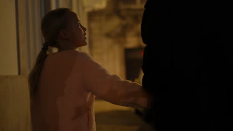 little girl holding parent hand walking in dark hallway