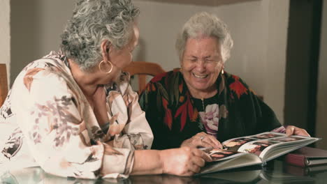 aged women examining photos together