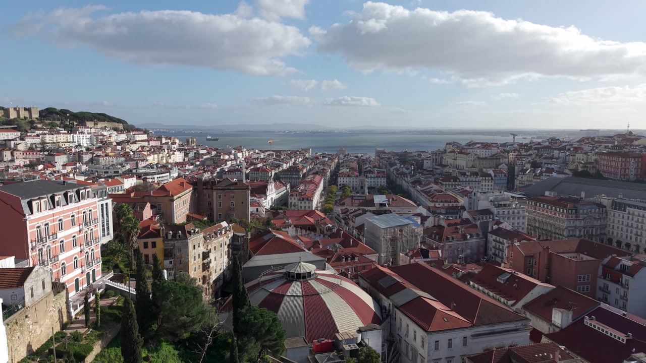 Lisbon old town charm, traditional buildings on Tagus river estuary, Drone shot