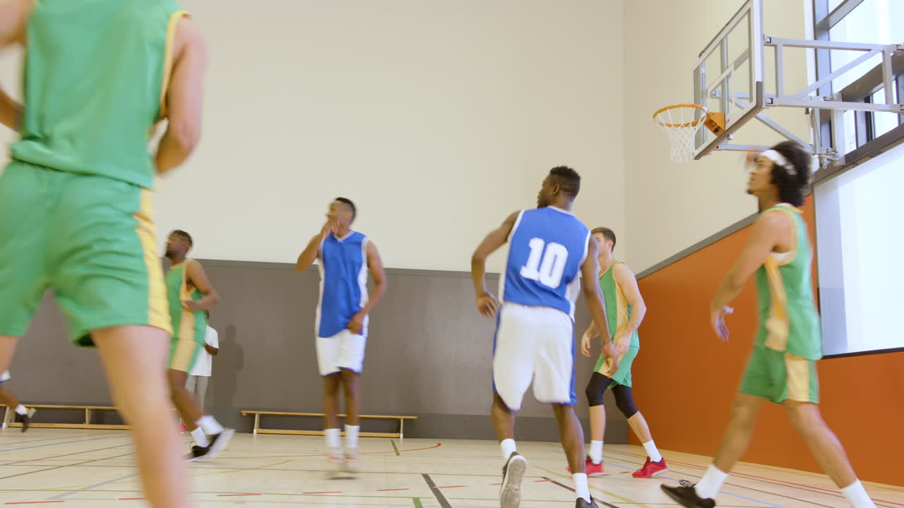 Basketball players in action on court, focusing on teamwork and strategy