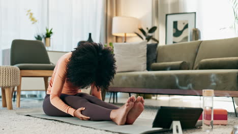woman doing yoga and stretching at home