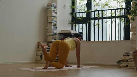 woman practicing yoga at home