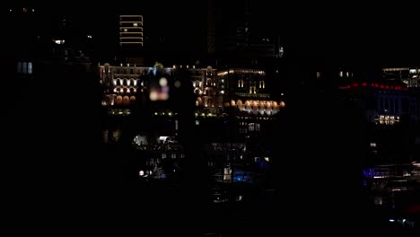nighttime silhouette shot of tourists taking photos of monaco at night