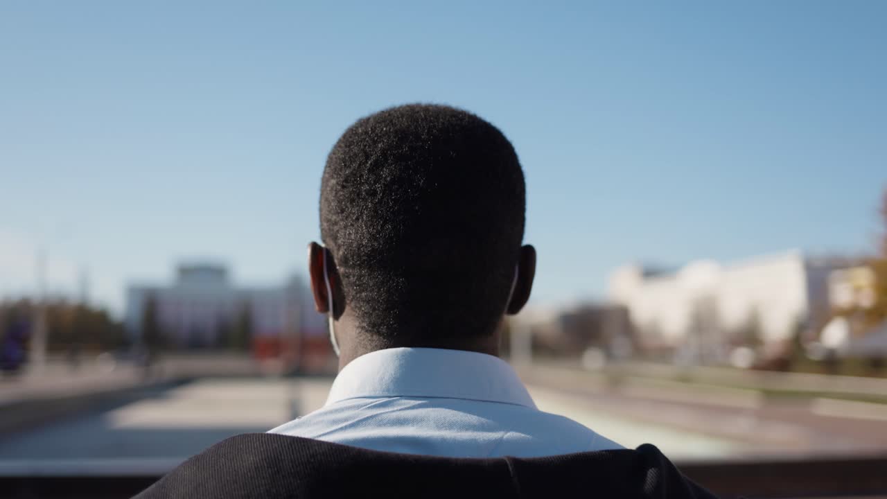 Man Adjusting Face Mask in City Park