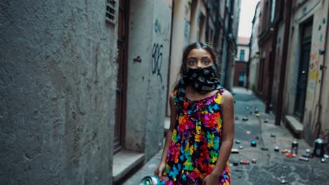 girl in a colorful dress and mask in a venetian alley