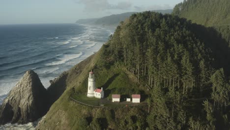 wide circumnavigating aerial revealing haceta head lighthouse in oregon