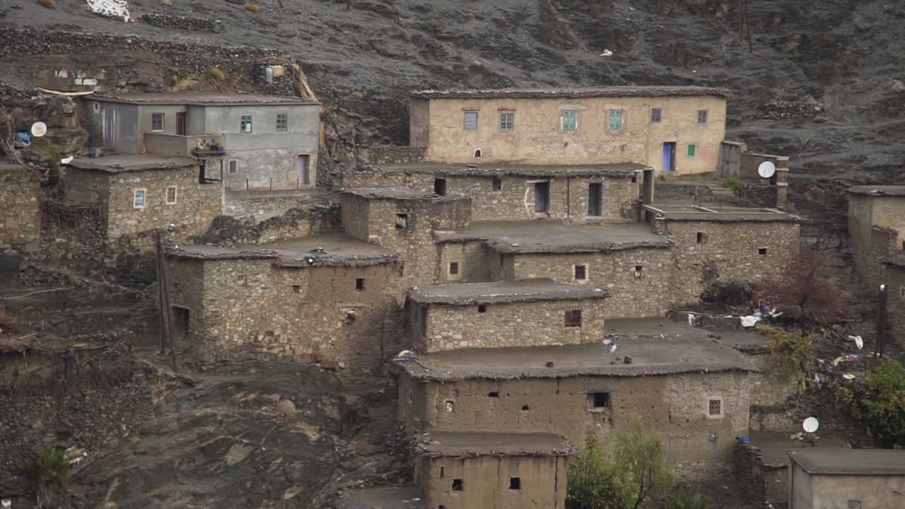 day shot of typical traditional berber village at mountain Atlas at Morocco Africa , cold cloud day adventure life , berber house