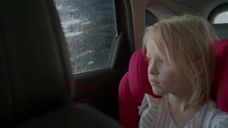 The-little-girl-is-sitting-in-the-car-in-the-car-wash