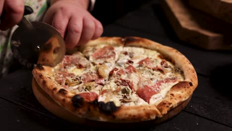 chef cutting a delicious homemade pizza