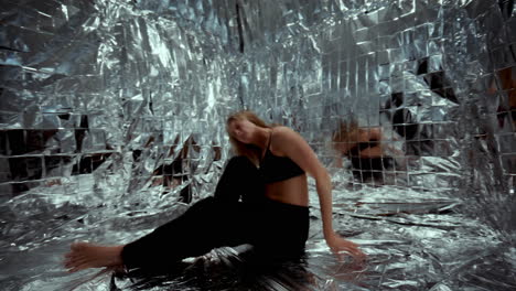 dancer expressing emotions through contemporary choreography on foil floor